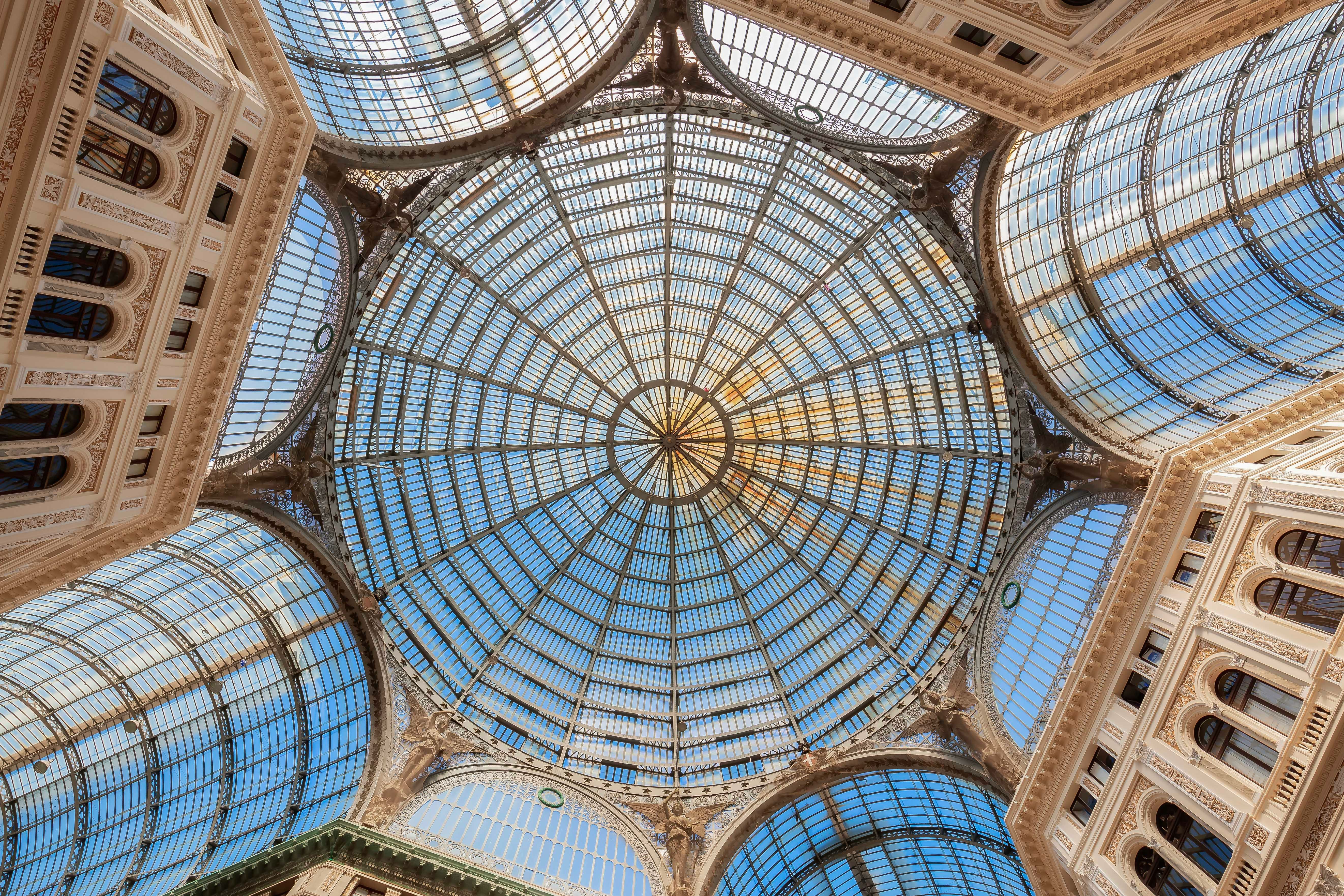 Galleria Umberto I interior with glass dome and ornate architecture in Naples, Italy.