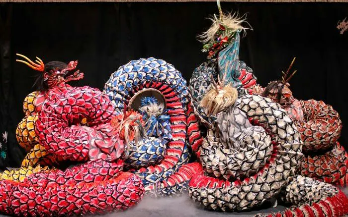 Kagura performers in colorful dragon costumes at Hiroshima show.