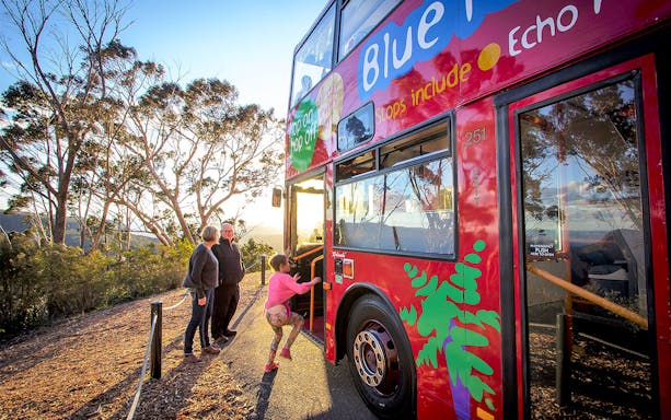Visitors boarding a double-decker bus for a guided tour of the Blue Mountains.