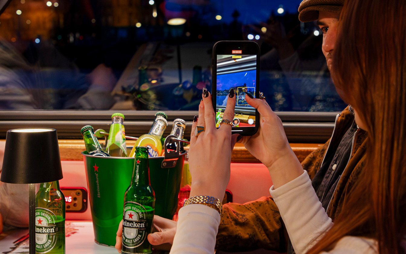 Guests enjoying drinks on the Lovers Canal Cruise in Amsterdam.