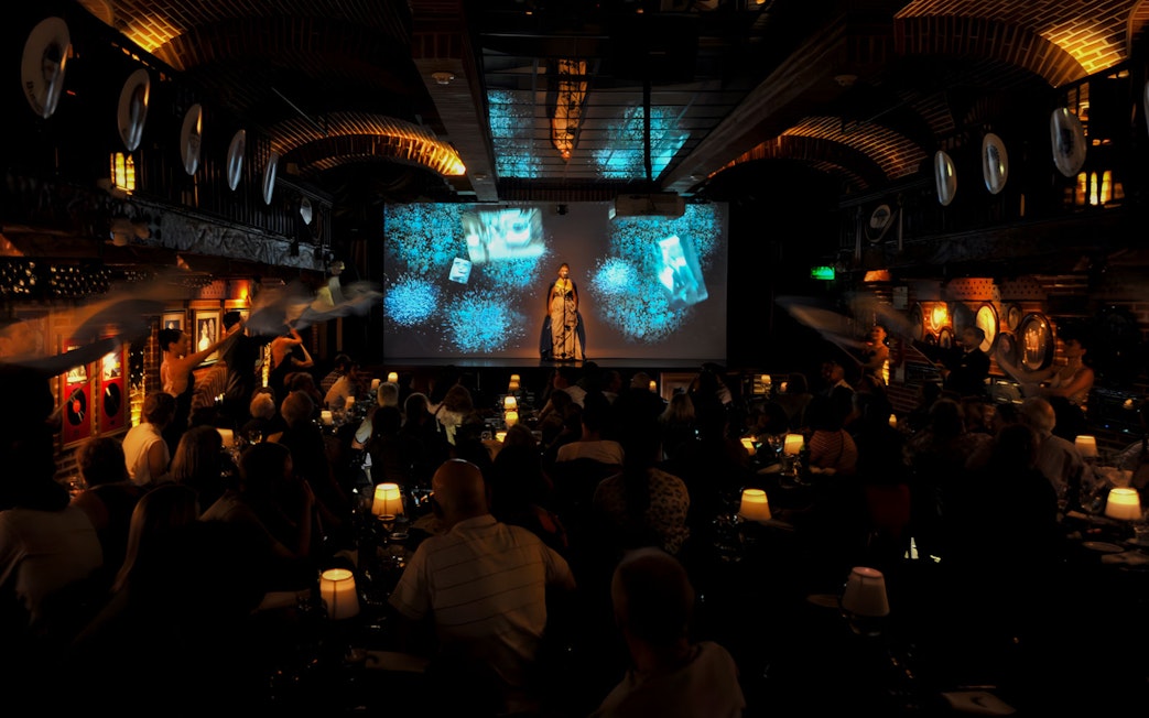 Audience enjoying Piazzolla Tango Show with performers on stage in Buenos Aires.