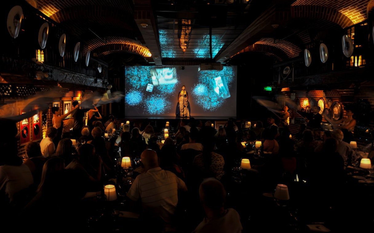 Audience enjoying Piazzolla Tango Show with performers on stage in Buenos Aires.