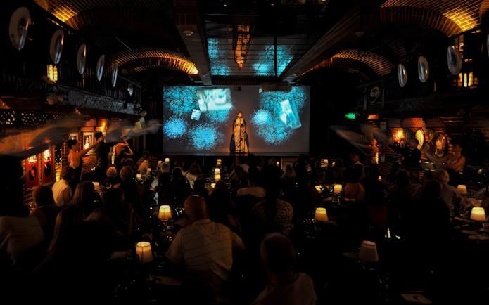 Audience enjoying Piazzolla Tango Show with performers on stage in Buenos Aires.