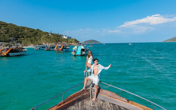 Tourists on a boat enjoying the Arraial do Cabo Full Day Tour with cruise in Brazil.