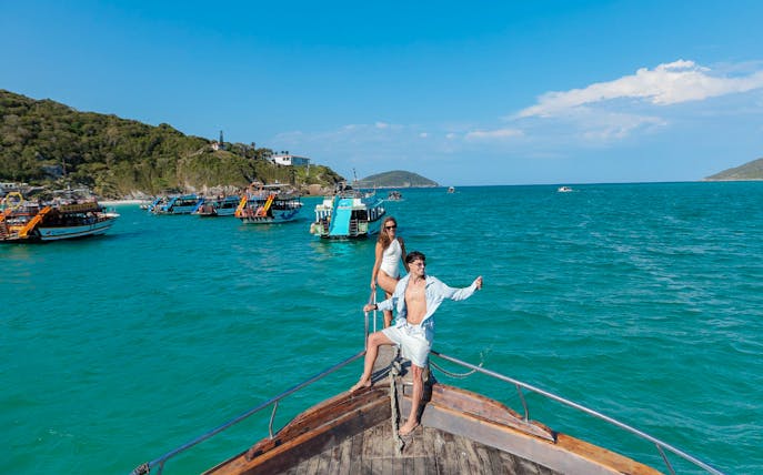 Tourists on a boat enjoying the Arraial do Cabo Full Day Tour with cruise in Brazil.