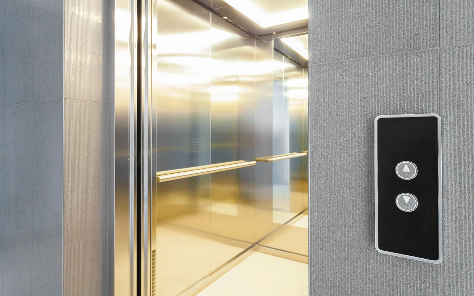 Elevator interior with control panel and open doors.