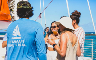 Group enjoying drinks on a Kaula Kai snorkel sail in Oahu.