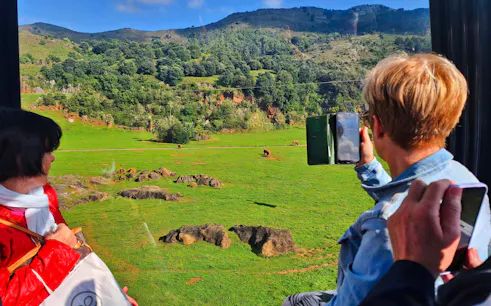Visitors viewing wildlife at Cabárceno Nature Park, Spain, from a cable car.