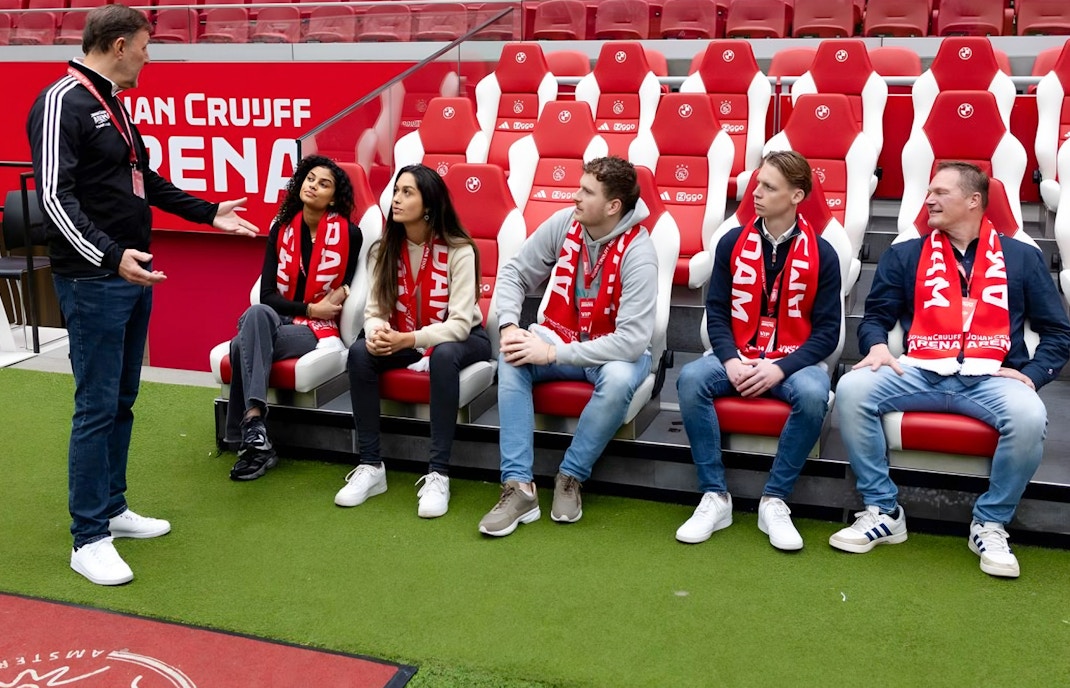 Visitors seated in Johan Cruijff ArenA, Amsterdam, during VIP tour with scarves.