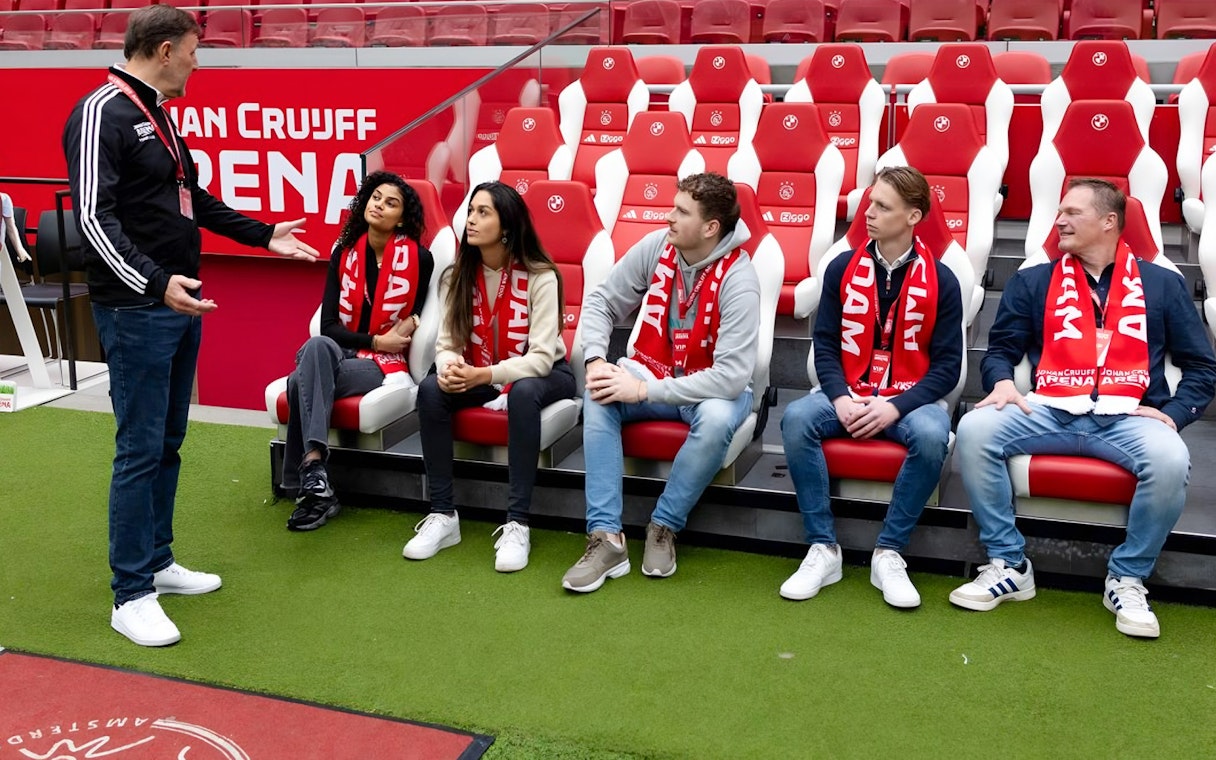 Visitors seated in Johan Cruijff ArenA, Amsterdam, during VIP tour with scarves.