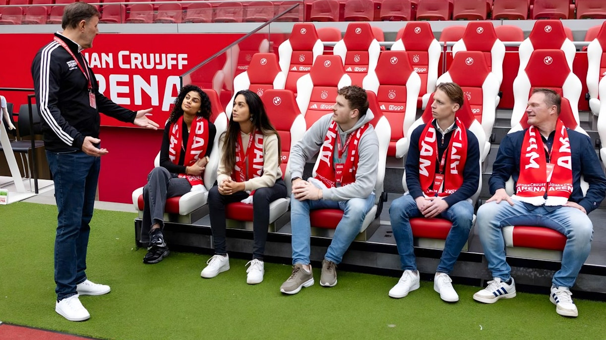 Visitors seated in Johan Cruijff ArenA, Amsterdam, during VIP tour with scarves.