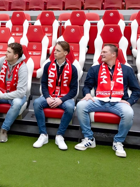 Visitors seated in Johan Cruijff ArenA, Amsterdam, during VIP tour with scarves.