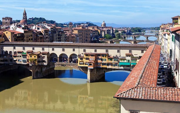 Ponte Vecchio over Arno River in Florence during guided walking tour.