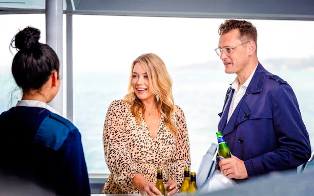 Guests enjoying drinks on Auckland Harbour sightseeing cruise.