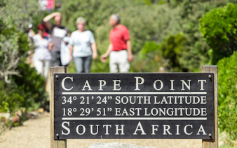 Cape Point sign with coordinates, South Africa pathway in background.