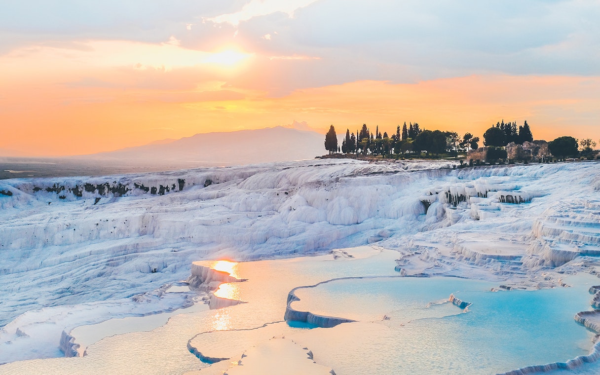 Pamukkale travertine terraces at sunset during guided day tour from Antalya.