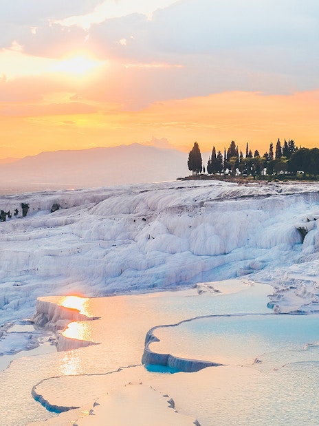 Pamukkale travertine terraces at sunset during guided day tour from Antalya.