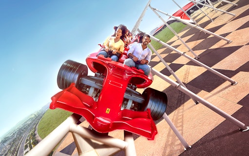 Riders on Formula Rossa roller coaster at Ferrari World Abu Dhabi, part of 1-Day 2-Park Pass.
