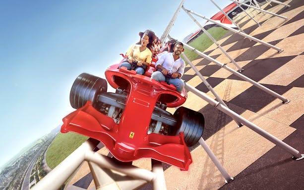 Riders on Formula Rossa roller coaster at Ferrari World Abu Dhabi, part of 1-Day 2-Park Pass.