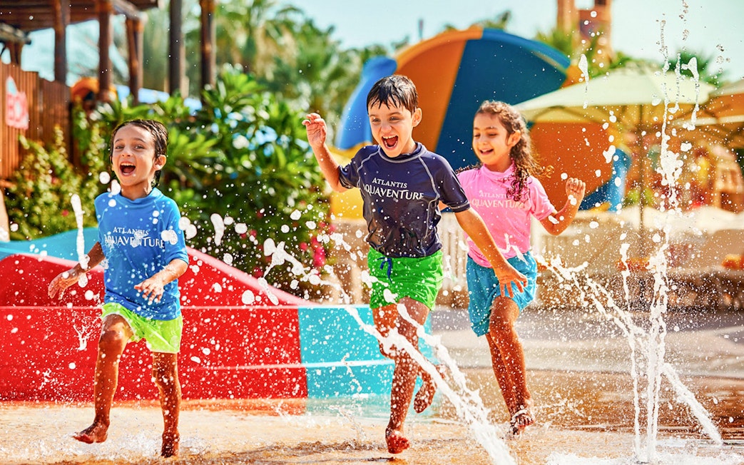 Children playing in splash area at Aquaventure Waterpark, Dubai.
