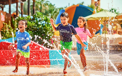 Children playing in splash area at Aquaventure Waterpark, Dubai.