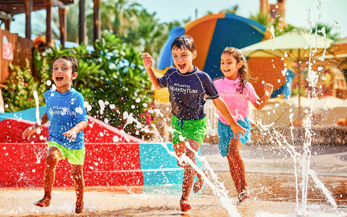 Children playing in splash area at Aquaventure Waterpark, Dubai.