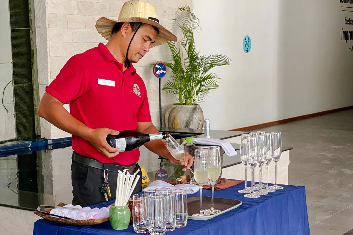 Server pouring drinks at Angkor Wildlife & Aquarium River Monster Experience, Siem Reap.