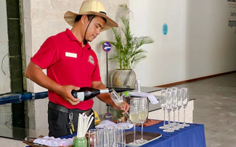 Server pouring drinks at Angkor Wildlife & Aquarium River Monster Experience, Siem Reap.