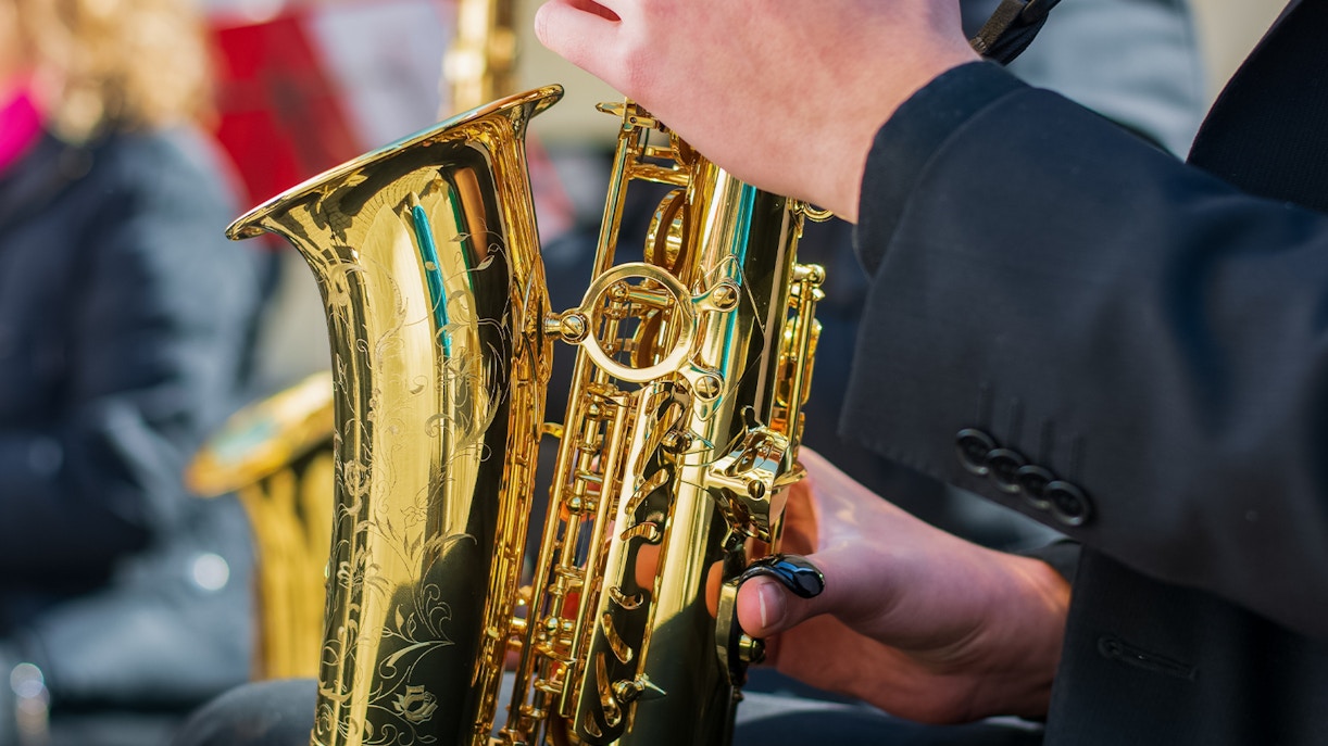 Saxophonist playing on a lively street