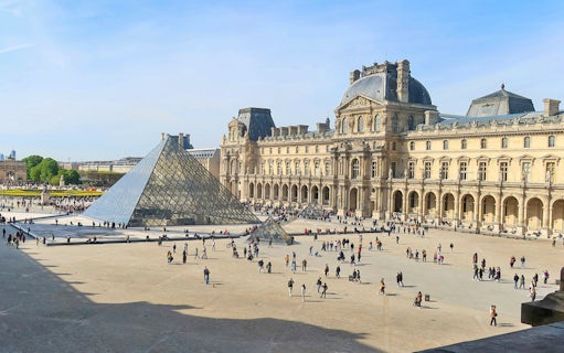 Louvre Museum courtyard with glass pyramid in Paris.