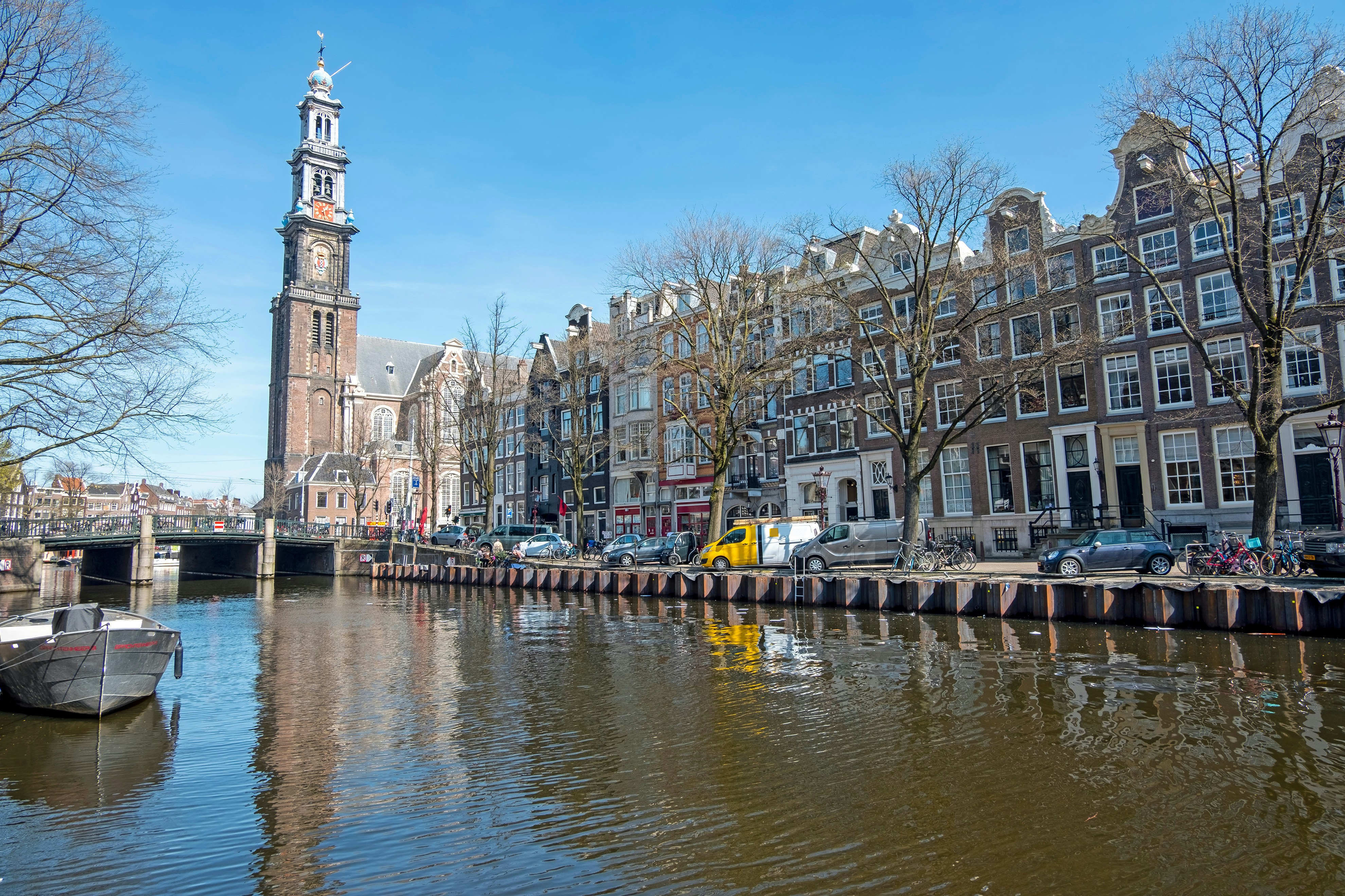 Westerkerk tower and canal view in Amsterdam, Netherlands.
