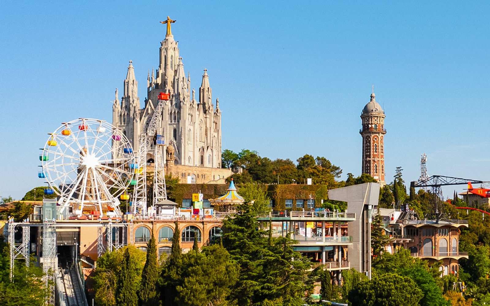 Tibidabo Amusement Park with Ferris wheel and church, overlooking Barcelona.