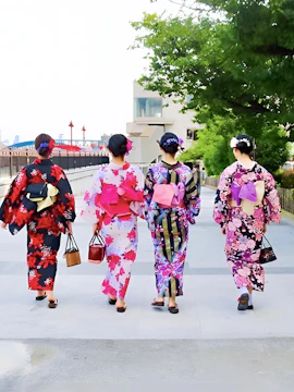 Women in colorful kimonos walking along a path in Tokyo, Japan.