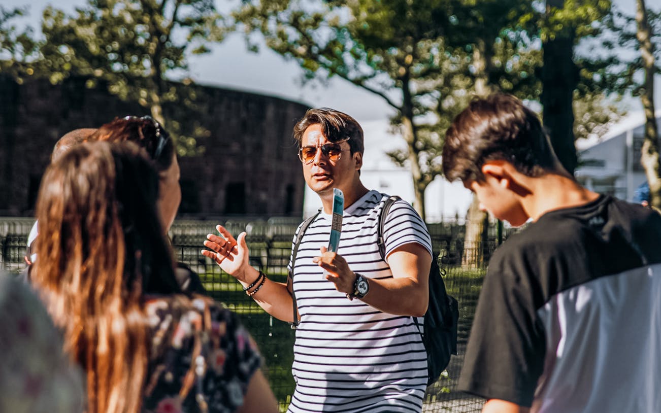 Tour guide explaining to visitors during Statue of Liberty tour with Ellis Island.