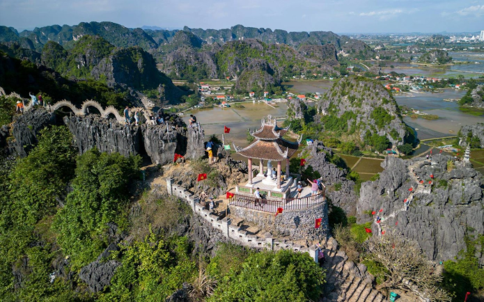 Aerial view of Hang Mua Viewpoint with pagoda and limestone karsts in Ninh Binh, Vietnam.