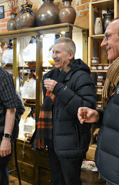 Group enjoying local drinks on Kraków street food tour.