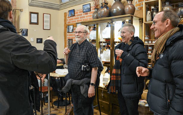 Group enjoying local drinks on Kraków street food tour.
