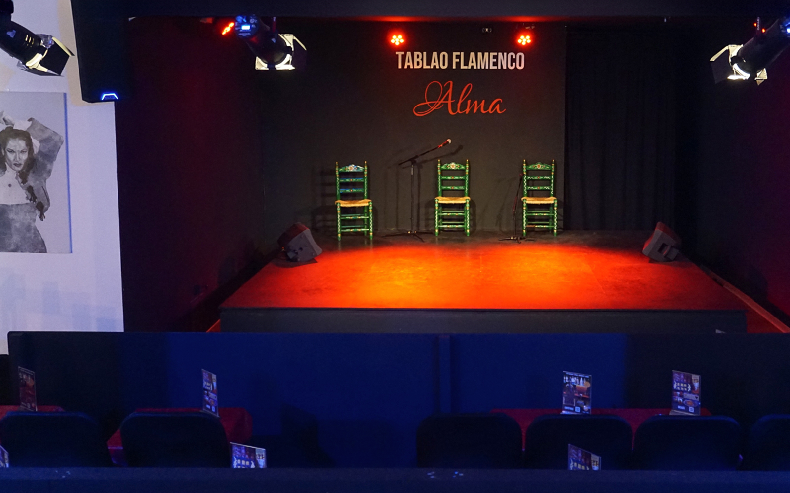 Stage setup for Flamenco Show at Tablao Flamenco Alma with chairs and microphone.
