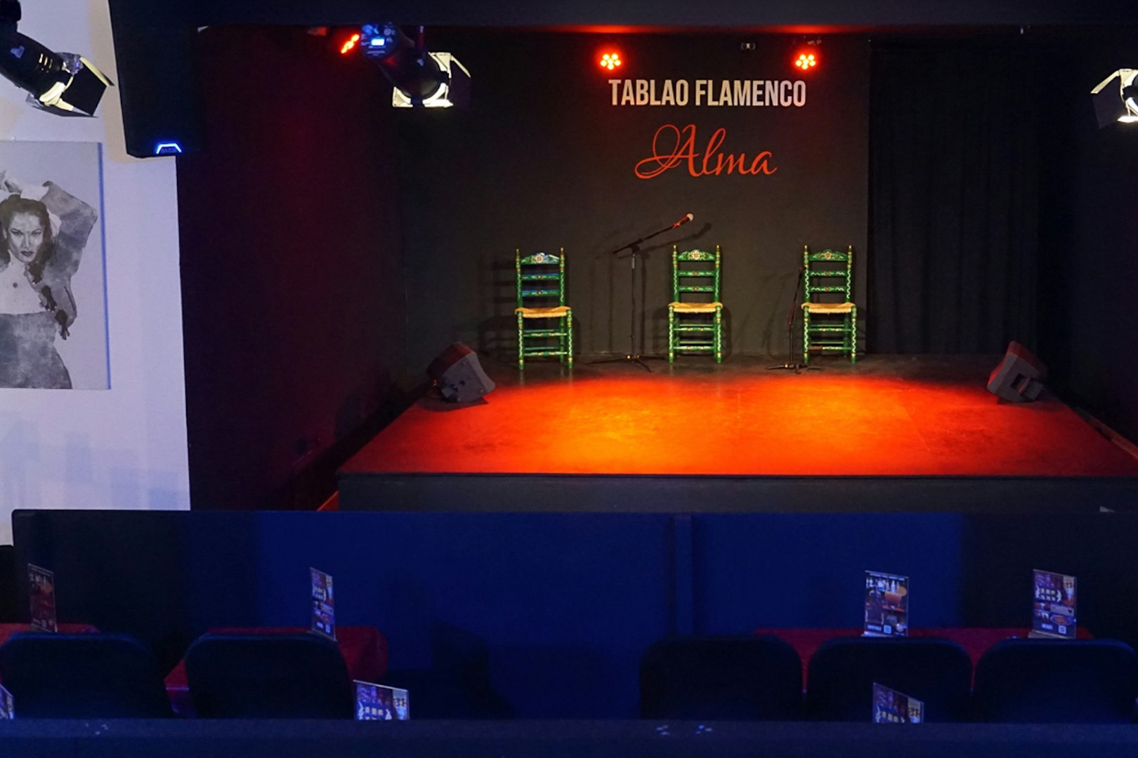 Stage setup for Flamenco Show at Tablao Flamenco Alma with chairs and microphone.