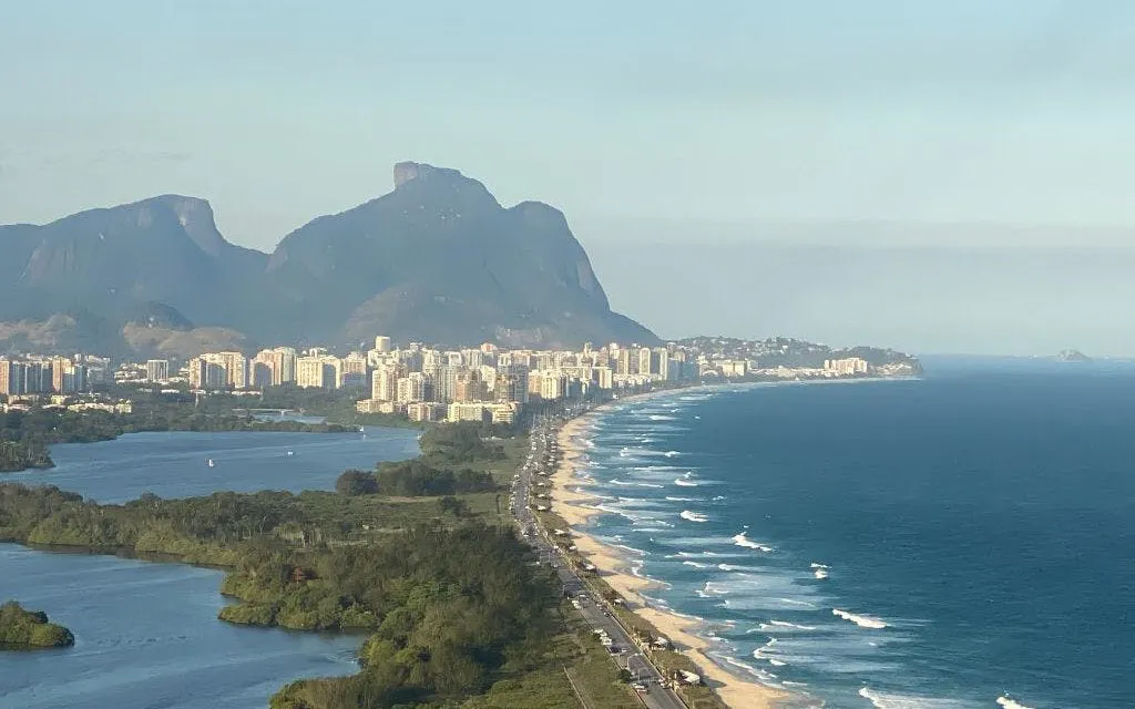 Coastline of Barra da Tijuca with mountains during Rio de Janeiro helicopter tour.