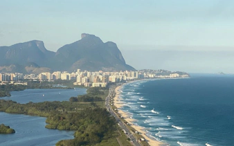 Coastline of Barra da Tijuca with mountains during Rio de Janeiro helicopter tour.