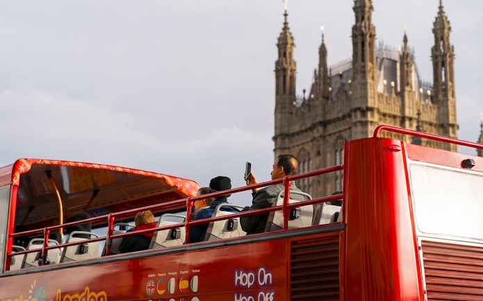 Open-top bus tour near Westminster Abbey, London.