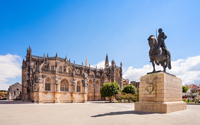 Batalha Monastery with equestrian statue in foreground, Batalha, Portugal.