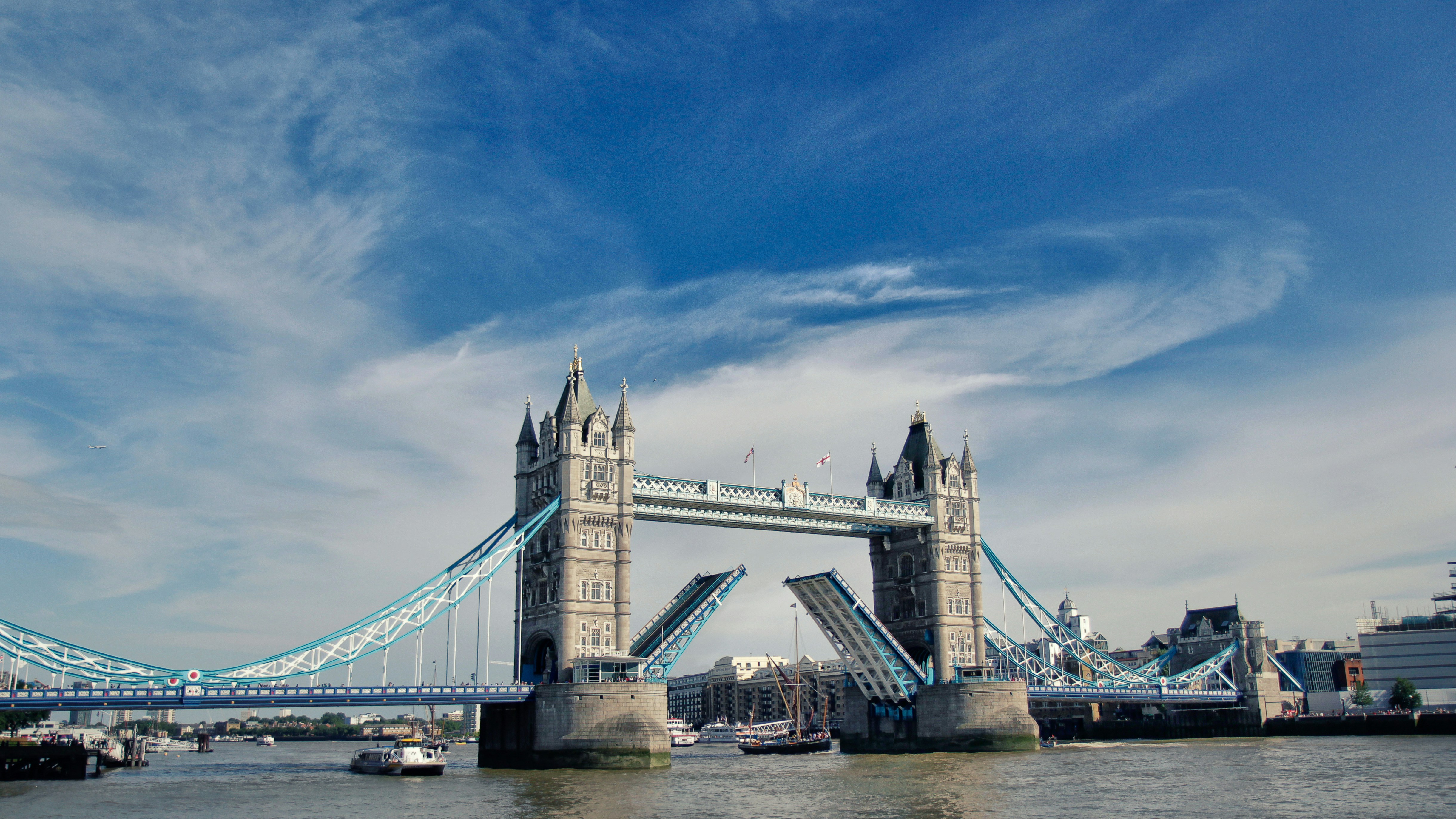 Tower Bridge in London with its bascules raised for a passing boat.