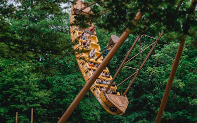 Tourists on a pirate ship ride at Bellewaerde Christmas park surrounded by trees.