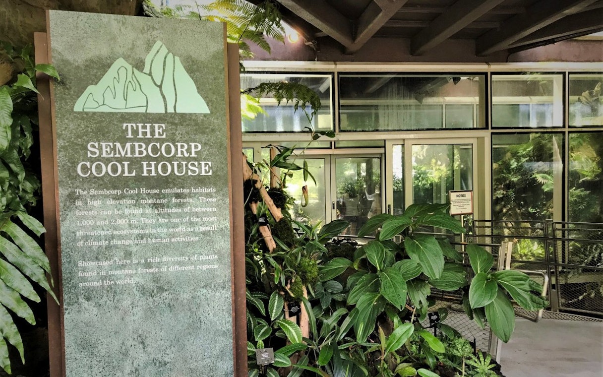 Sembcorp Cool House entrance with lush plants at National Orchid Garden, Singapore.
