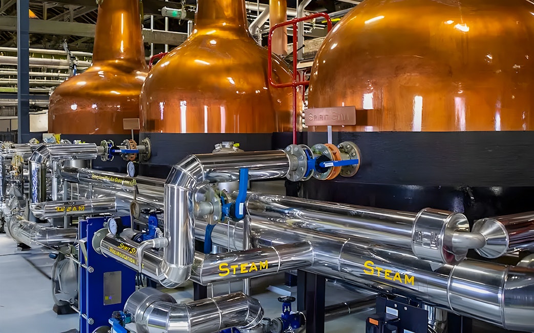 Copper pot stills and stainless steel pipes at Midleton Distillery, Ireland.