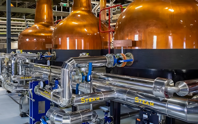 Copper pot stills and stainless steel pipes at Midleton Distillery, Ireland.