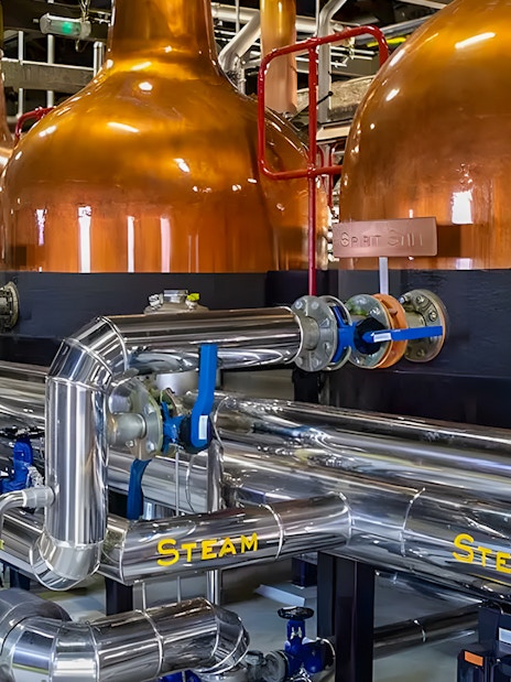 Copper pot stills and stainless steel pipes at Midleton Distillery, Ireland.