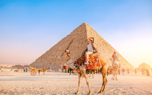 Camel ride near the Pyramid of Khafre at the Giza Complex, Egypt.